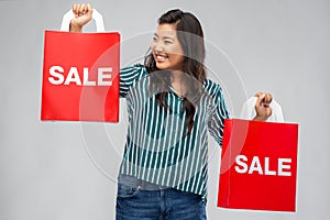 Happy asian woman with shopping bags