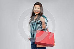 Happy asian woman with shopping bags