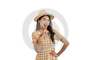 Happy Asian woman shows shush sign, shut your mouth, finger on lips isolated on white background