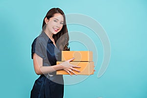 Happy Asian woman smiling and holding package parcel box isolated on white background, Delivery courier and shipping service