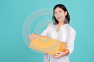 Happy Asian woman smiling in white casual dress standing smiling and looking at camera. She is holding package parcel box isolated