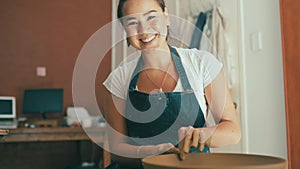 Happy asian woman, spinning table and pottery for bowl, vase or ceramics in creative art at workshop. Portrait of female