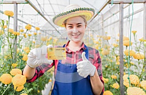 Happy asian woman standing and holding credit card photo