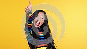 Happy asian woman suddenly appears and showing thumb up sign