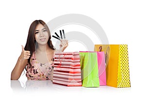 Happy Asian woman thumbs up with credit cards and shopping bags