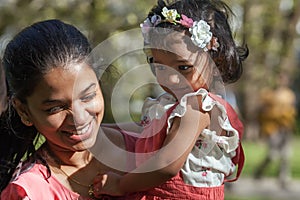 A happy Asian woman with two years old girl in spring park
