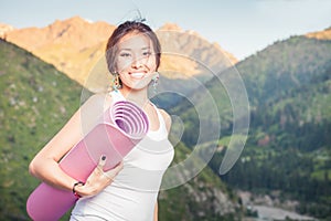 Happy asian woman with yoga mat going to fitness exercises