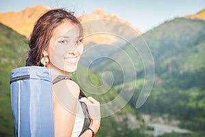 Happy asian woman with yoga mat going to fitness exercises