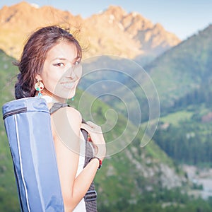 Happy asian woman with yoga mat going to fitness exercises