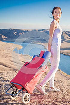 Happy asian woman with yoga mat going to fitness exercises