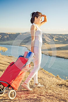 Happy asian woman with yoga mat going to fitness exercises