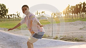 Happy asian women exercise surf skate at parking in her house,