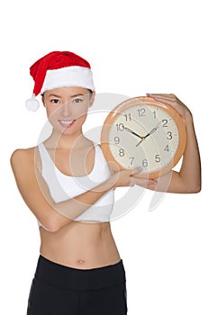 Happy asian women in a Santa`s hat with a clock