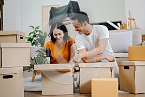 Happy asian young attractive couple man and woman with big boxes moving into a new house, new apartment for couple the new home,