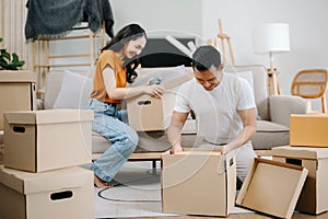 Happy asian young attractive couple man and woman with big boxes moving into a new house, new apartment for couple the new home,