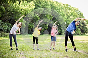 Happy asian young family exercising  together at the park