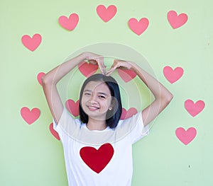 Happy Asian young girl with many heart background