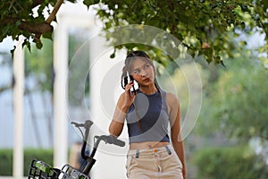 Happy Asian young woman ride bicycle in park, street city her smiling using bike of transportation, ECO friendly, People