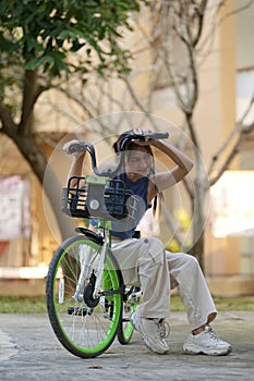 Happy Asian young woman ride bicycle in park, street city her smiling using bike of transportation, ECO friendly, People