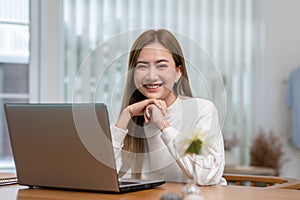 Happy asian young woman smile with computer laptop working at home office. Entrepreneur Freelance woman working online sale