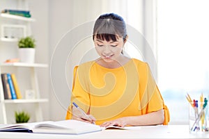 Happy asian young woman student learning at home