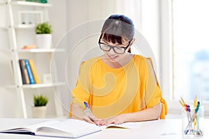 Happy asian young woman student learning at home