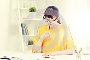 Happy asian young woman student learning at home