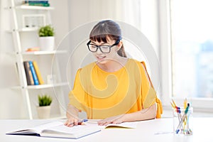 Happy asian young woman student learning at home