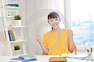 Happy asian young woman student learning at home