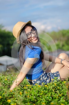 Happy Asians female in cowgirl hat and wear glasses looking at