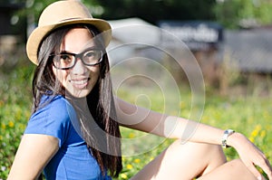 Happy Asians female in cowgirl hat and wear glasses looking at