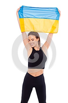 Happy athlete woman holding flag of Ukraine  on white