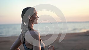 Happy athletic blonde woman running jogging sunset beach nature landscape slow motion