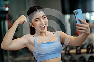 Happy Attractive fit young woman taking selfie after workout at gym