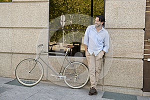 Happy attractive latin man in casual trendy clothes smiling cheerful riding on vintage cool retro bicycle
