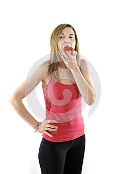 Happy attractive mature woman on her 40s eating apple fruit in diet concept