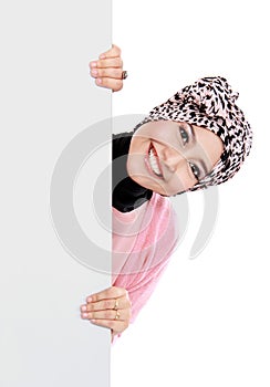 Happy attractive muslim woman holding blank white board