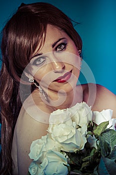 Happy, attractive woman with bouquet of white roses