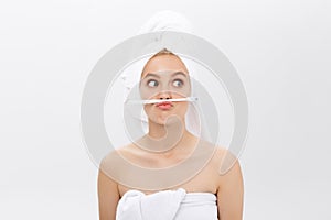 Happy attractive woman playing with tooth brush on copy space, isolated on white