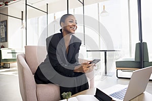 Happy attractive young African American business lady using Internet technology