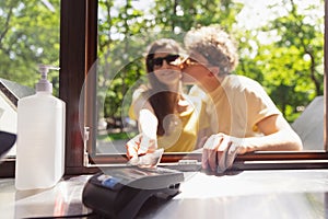 Happy attractive young couple romantically eating a fresh pizza outdoors.