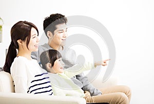 Happy Attractive Young Family watching the tv
