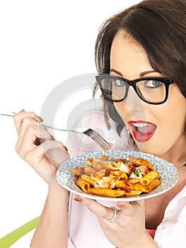 Happy Attractive Young Hispanic Woman Eating a Plate of Tomato and Basil Penne Pasta