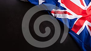 Happy Australia day concept. Australian flag against dark stone background. 26 January