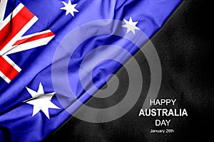 Happy Australia Day - January 26th. Australian flag on dark background