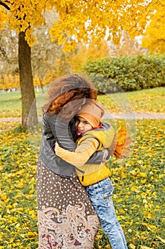 Happy Autumn Mother and Child Boy Hugging