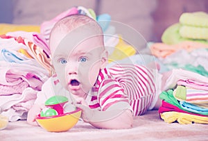 Happy baby with baby`s things