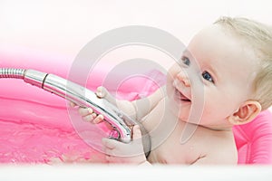 Happy baby in a bathtub