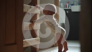 happy baby boy crawling on floor toddler exploring home curious infant having fun enjoying childhood. Little Cute