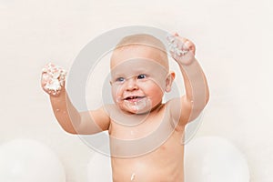 Happy baby boy eating birthday cake. Cake smash